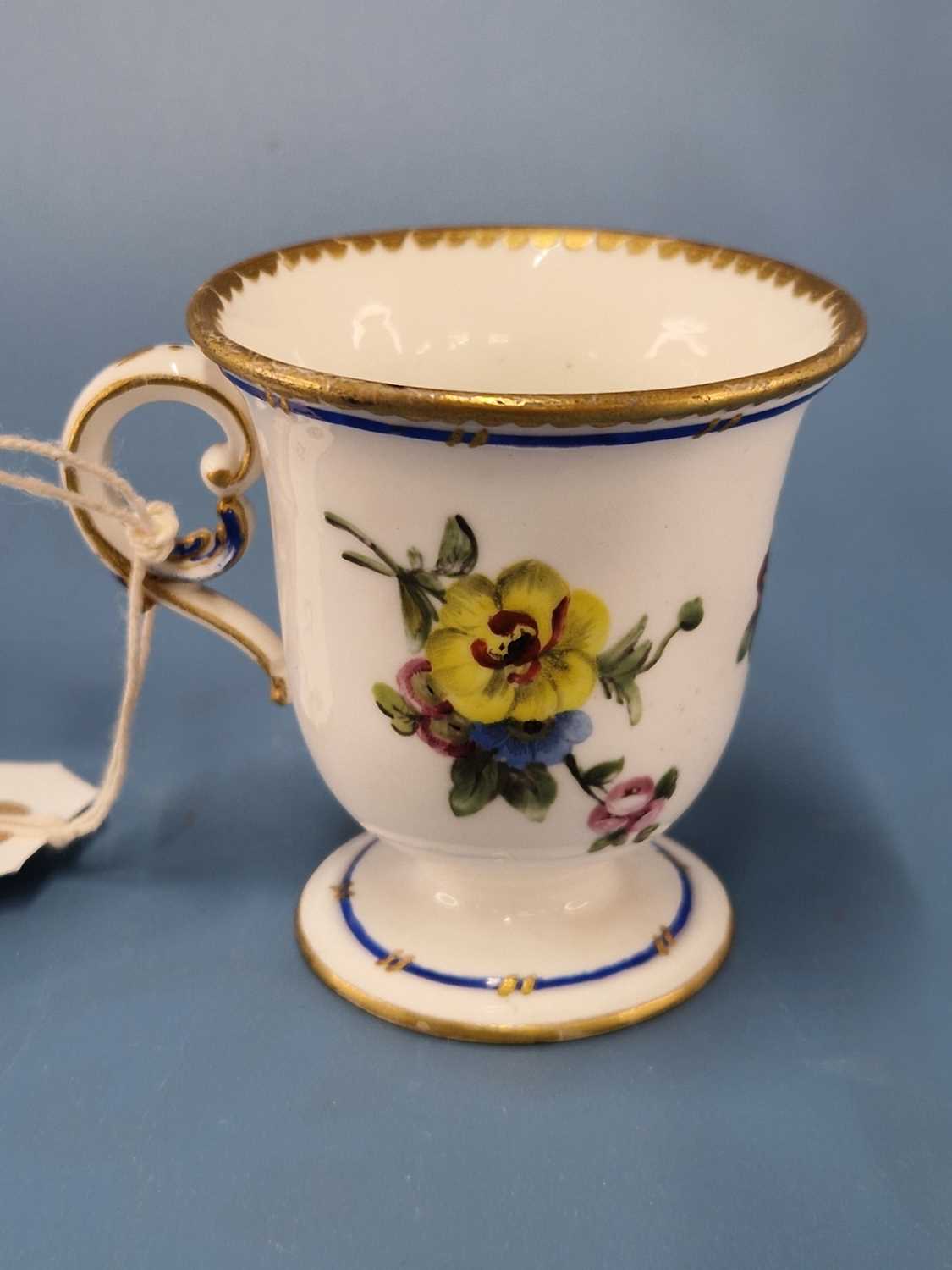 A Sevres ice cup painted with a blue line and flower sprays below a gilt dentil rim line The - Image 2 of 6