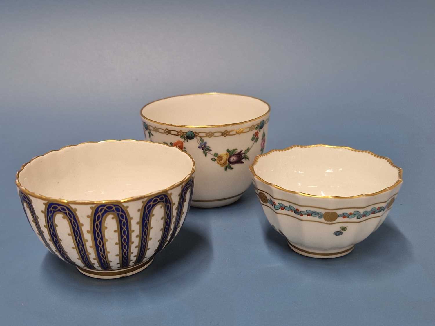 A Derby tea bowl gilt about Smiths blue loops, blue mark, a tea bowl painted with floral swags