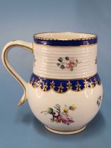 A Chelsea Derby mug with a ribbed neck band above Smiths blue lappets and painted flowers, gilt
