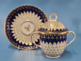 A Derby two handled cup, cover and saucer with royal blue rims enclosing gilt and moulded
