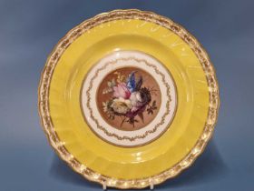 A Derby plate painted with a floral roundel (possibly by William Billingsley) central to a fluted