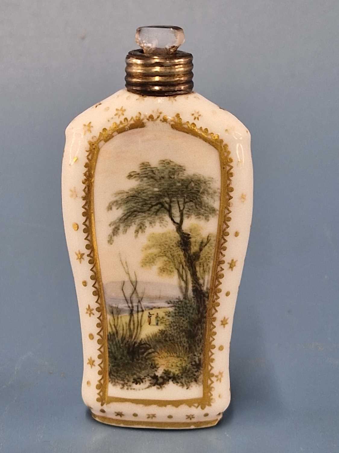 A Derby scent bottle painted on each side with a landscape below the gold screw top The screw top