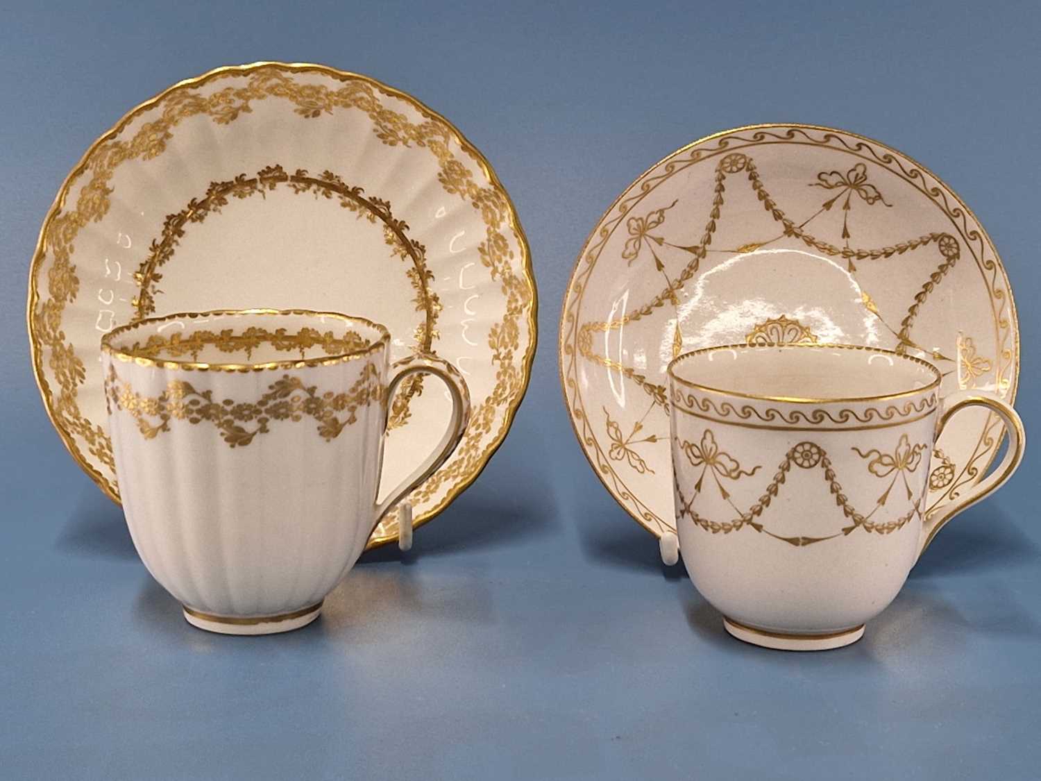 A Derby coffee cup and saucer gilt with swags, blue marks together with a ribbed coffee cup and