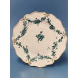 A Derby plate painted with green floral swags within a gilt dentil line on the wavy rim, RF 126 This