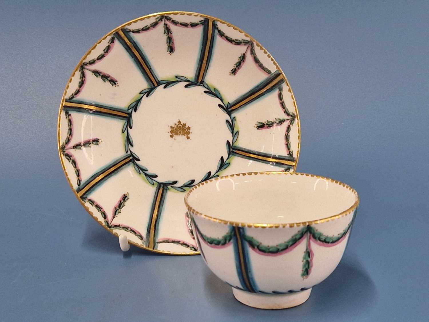 A Chelsea Derby tea bowl and saucer painted in pink, turquoise and green with drapery swags in - Image 2 of 2