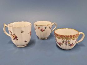 Two Derby fluted coffee cups painted with swags of flowers together with a ribbed cup painted with