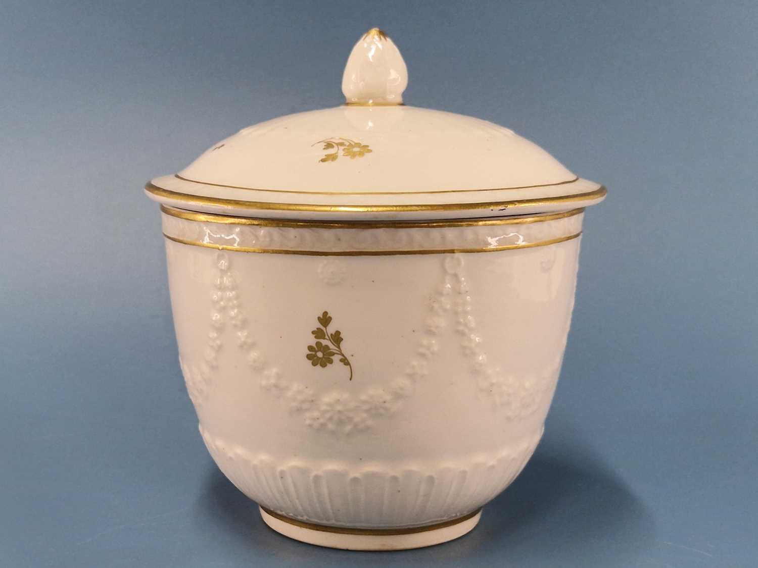 A Derby sugar pot and cover moulded with floral swags and gilt with sprigs, RF 15 Good condition