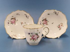 A Chelsea Derby coffee cup and two saucers painted in the manner of Edward Withers with sprigs and