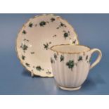 A Chelsea Derby fluted coffee cup and saucer painted with green rose swags within gilt dentil