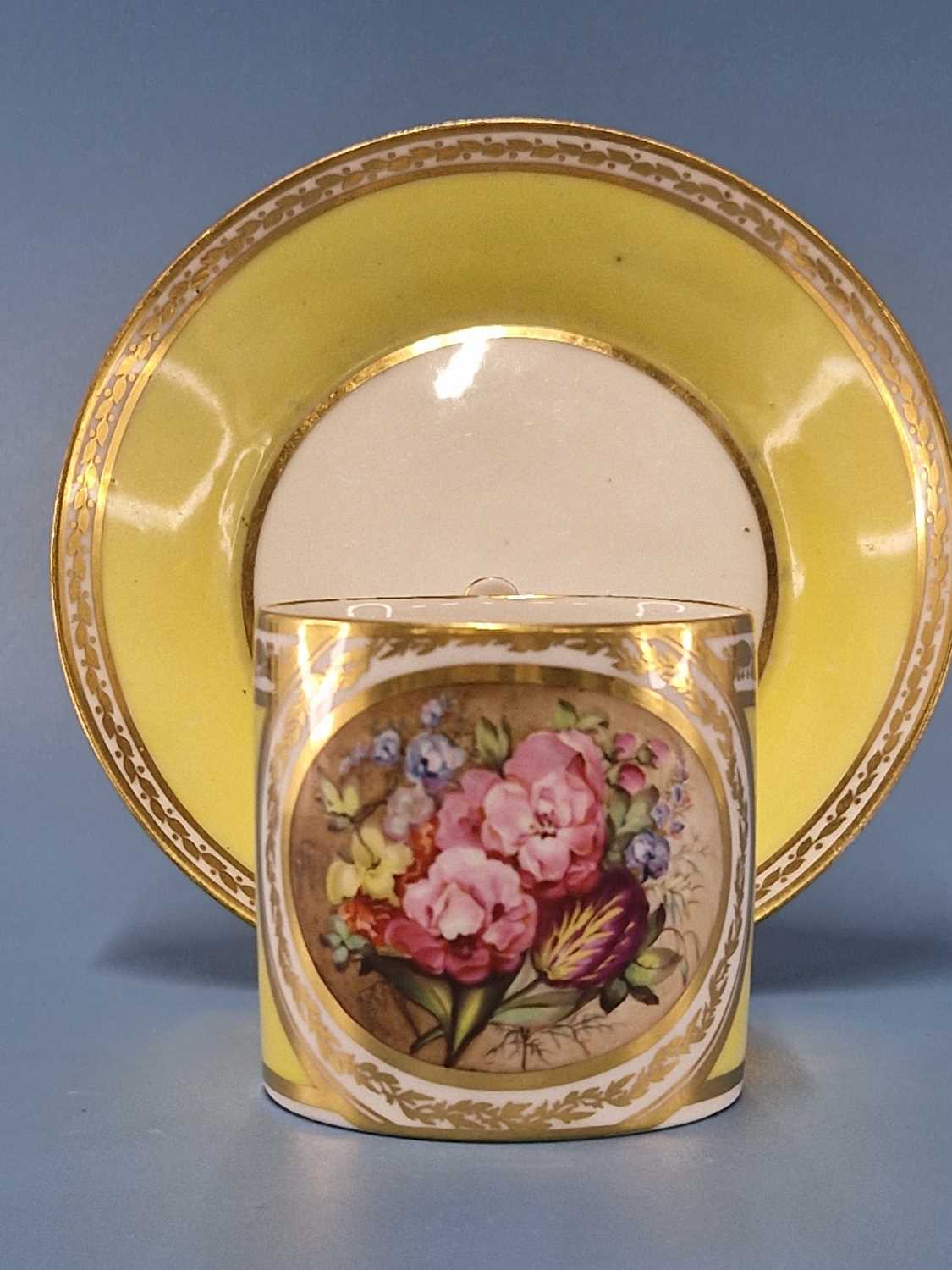 A Derby yellow ground coffee can and saucer, the former painted with a roundel of flowers, puce