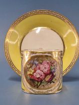 A Derby yellow ground coffee can and saucer, the former painted with a roundel of flowers, puce