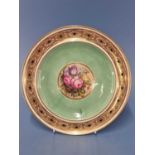 A Derby plate painted by William Pegg with flowers central to green and guilloche bands, blue