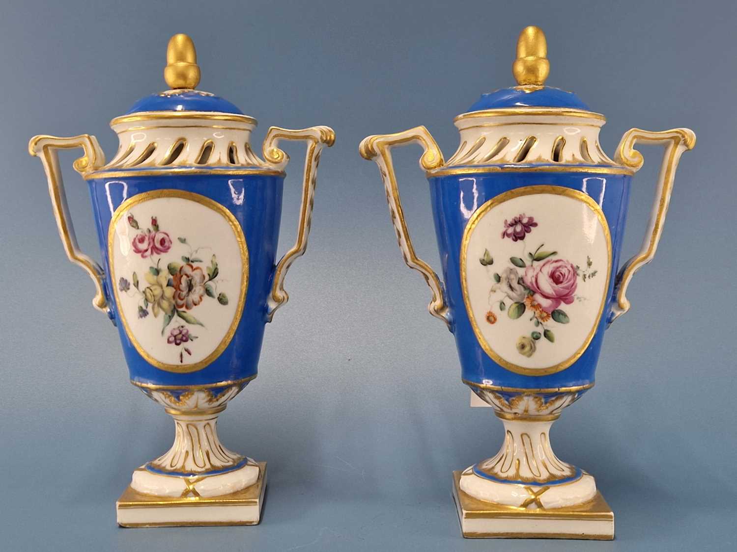 A pair of 'Sevres' turquoise ground pot pourri vases with square feet and with covers Both cover