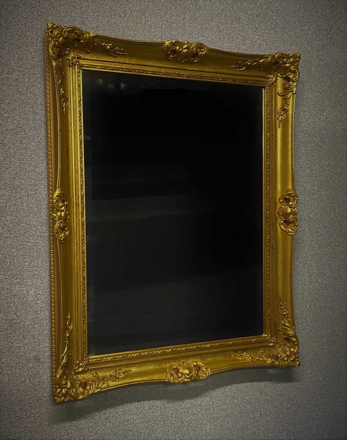 GILT SWEPT FRAME MIRROR. 740 x 590 mm