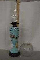 Green glass oil lamp with floral decoration and white shade