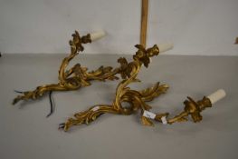 Two gilt metal wall lights in 18th Century Rococo style both with two branch candelabra (wired for