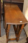 A drop leaf table with barley twist legs