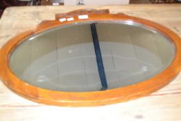 Oval mirror in wooden frame