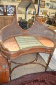 A Art Nouveau style kidney shaped dressing table with cane sides and mirror