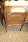 A small bow fronted three drawer cabinet, distressed condition