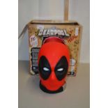 A boxed model of a Deadpool head