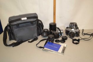 An Olympus camera with accessories