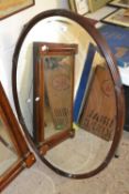 Large oval shaped mirror in wooden frame