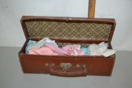 Small rectangular case containing a quantity of doll clothes