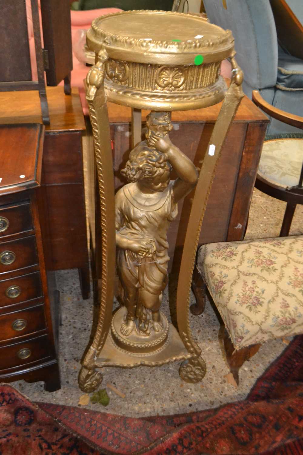 Gilt coloured jardiniere with a central column of a putto