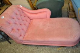 A pink upholstered chaise longue