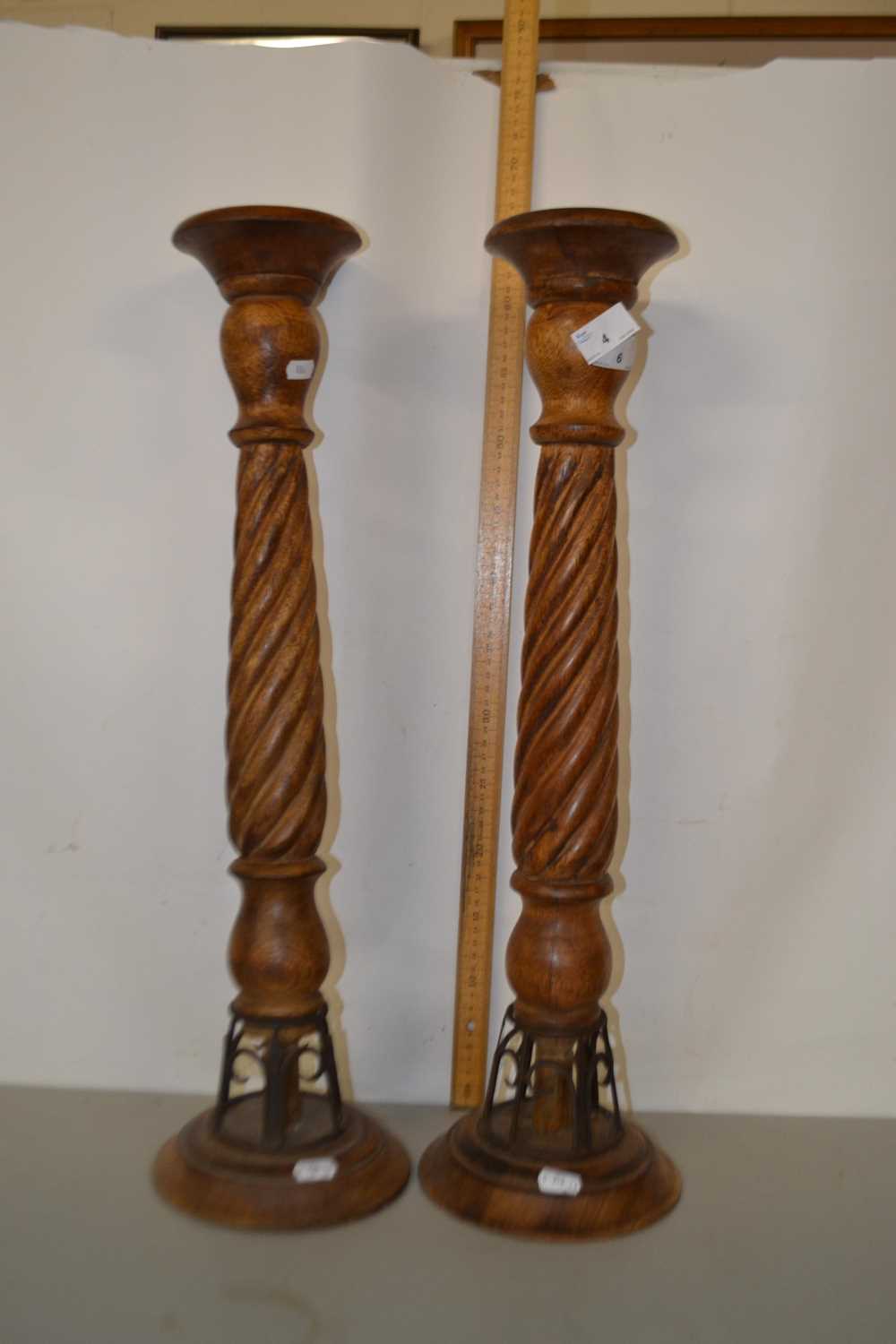 A pair of modern turned wooden candle stands