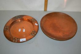 A copper plate decorated in Arts & Crafts style together with a further copper dish, plate 26cm
