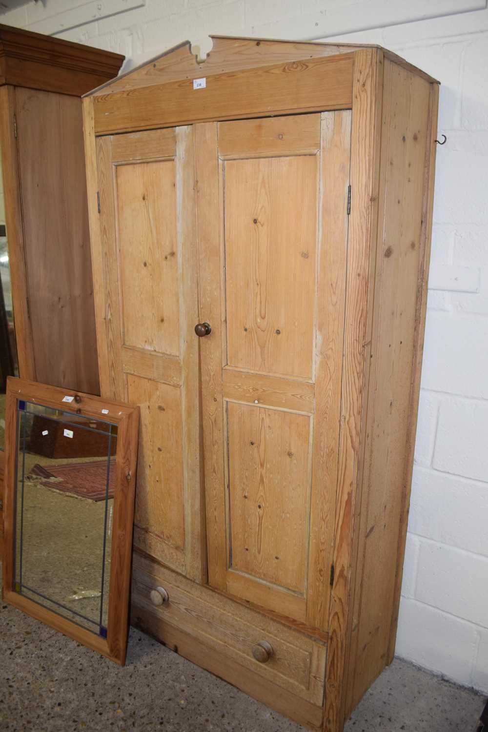 A small pine two door, one drawer wardrobe