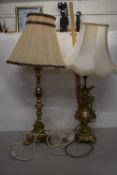 Two brass based table lamps with cream shades