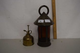 An Arts & Crafts style amber glass lantern together with a brass watering can