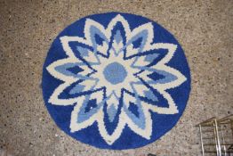 Small circular blue floor rug