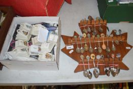 A quantity of collectors teaspoons on maple leaf shaped rack together with a quantity of Goss cheese