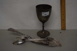 White metal goblet together with set of serving spoons and a fish slice
