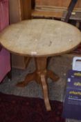 A bleached oak tripod based small dining table