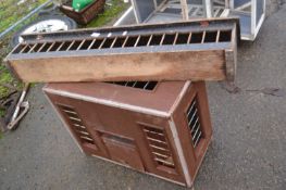 A pigeon crate and feeder