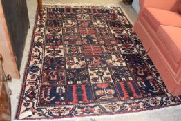 Middle Eastern wool floor rug with central geometric panel of floral and stylised motiffs, 250 x