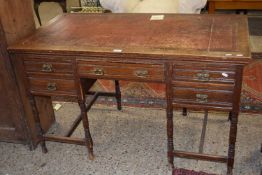 A late Victorian oak desk with leather inset top