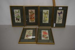 Six butterfly and floral woven pictures, framed