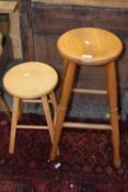 An oak kitchen stool and a further small stool or occasional table