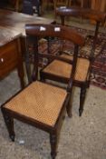 A pair of 19th Century cane seated bar back dining chairs