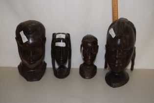 A pair of hardwood carved figure heads, approx 25cm high together with another pair, smaller