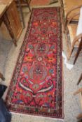 20th Century Middle Eastern runner carpet decorated in floral design on a red background, 275cm