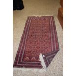 20th Century Middle Eastern wool floor rug with geometric pattern on a red background