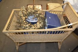 A wicker cot and other items