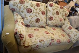 A floral upholstered two seater sofa